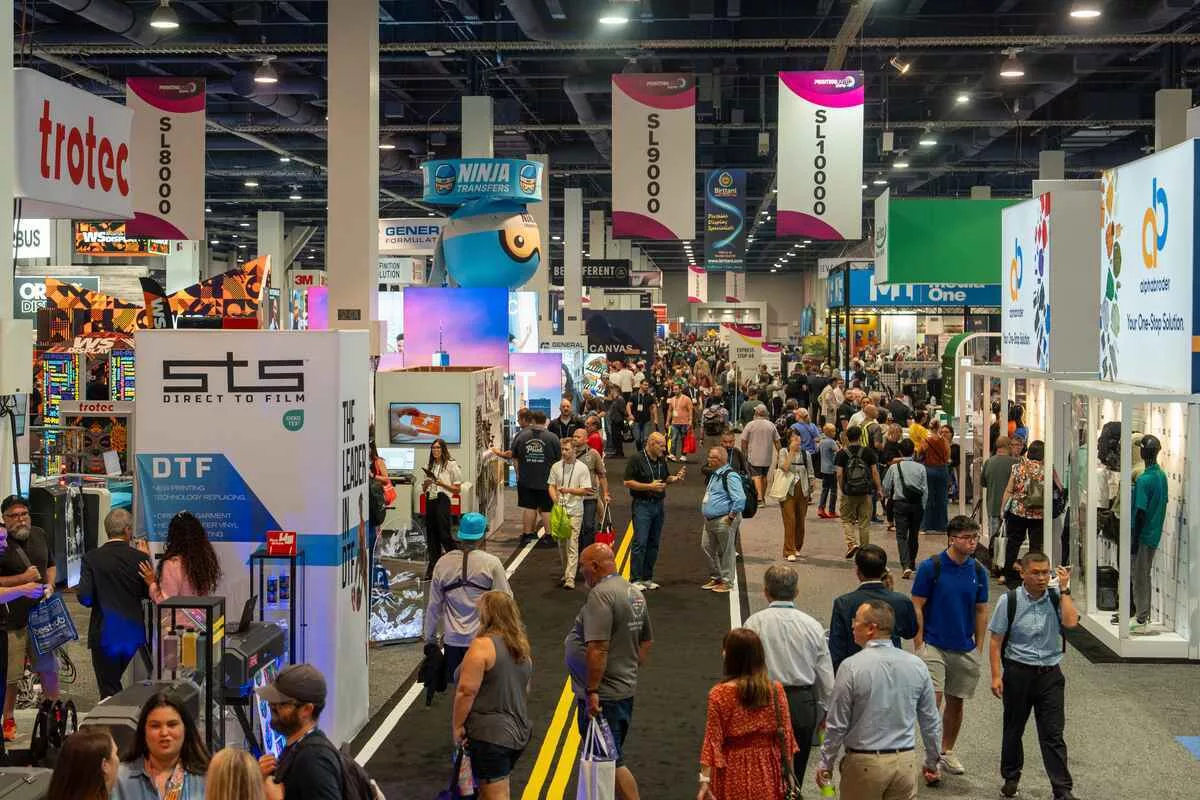 Conference attendees gathered around an interactive brand activation booth at a Las Vegas technology expo